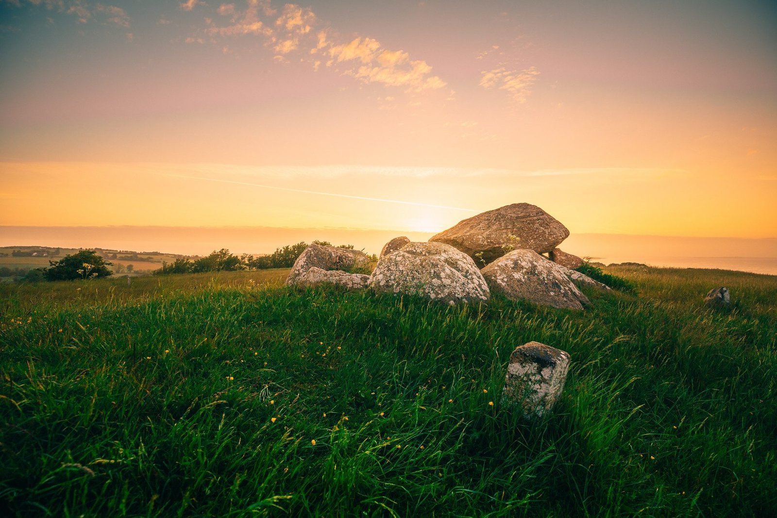 Grote stenen in een weiland op Ærø bij zonsondergang